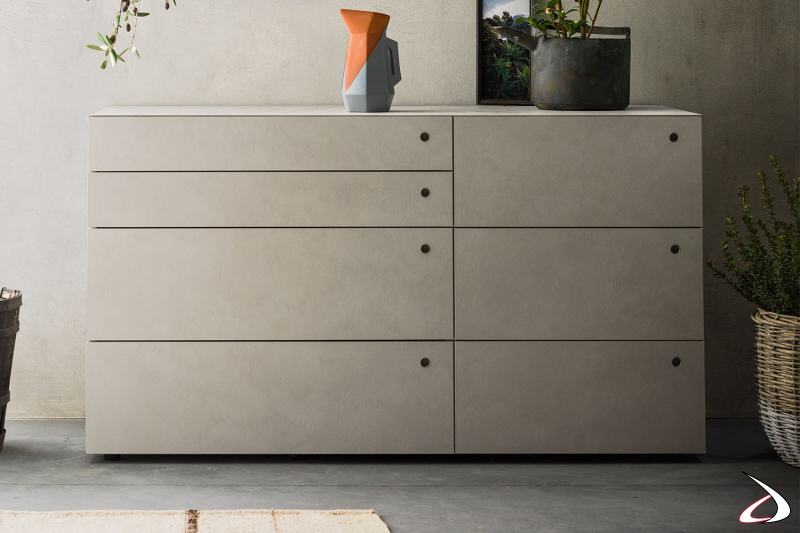 Chest of drawers with five drawers and two smaller ones, in melamine with hole handles for a minimalist and clean design. 