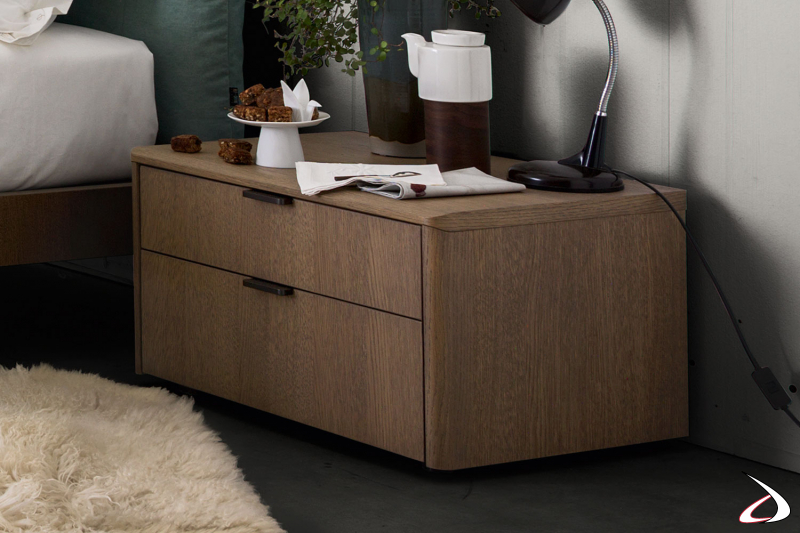 Elegant floor-standing bedside table with special rounded top joint and shaped sides.