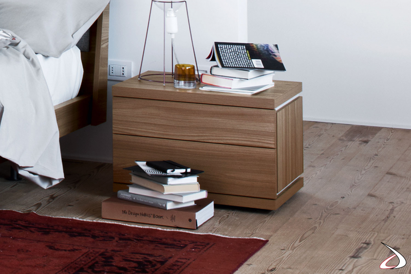 Modern nightstand with a minimalist design in wood with contrasting white grooves. 
