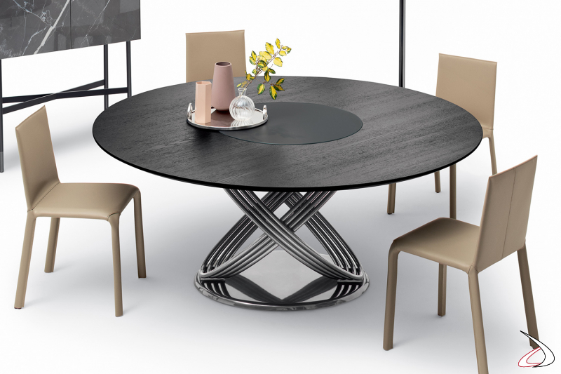 Tavolo rotondo di design con basamento ad anelli in argento naturale e top con piano centrale girevole incassato