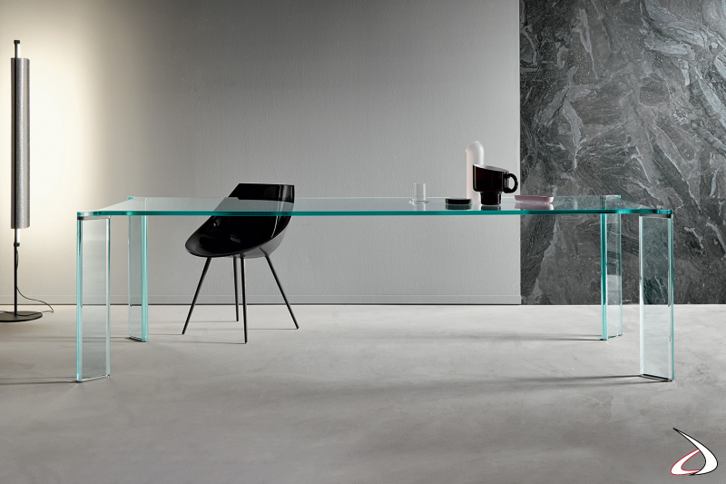 Tavolo moderno ed elegante realizzato interamente in vetro e con piastre terminali delle gambe in metallo.