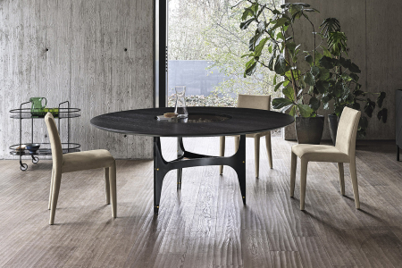 Tavolo rotondo elegante in legno impiallacciato con piano centrale girevole incassato in cristallo fumè