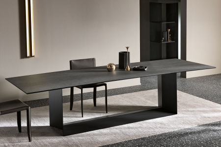 Tavolo moderno e di design che si caratterizza per il particolare basamento in metallo e il top in pietra di Savoia antracite opaco.