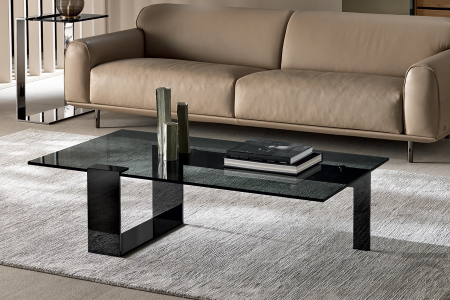 Modern coffee table and elegant white painted metal support that wraps and supports the glass top.
