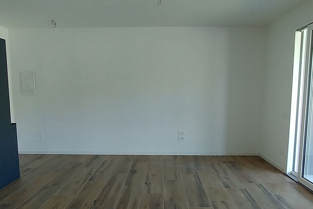 Open-plan living area before the refurbishment project